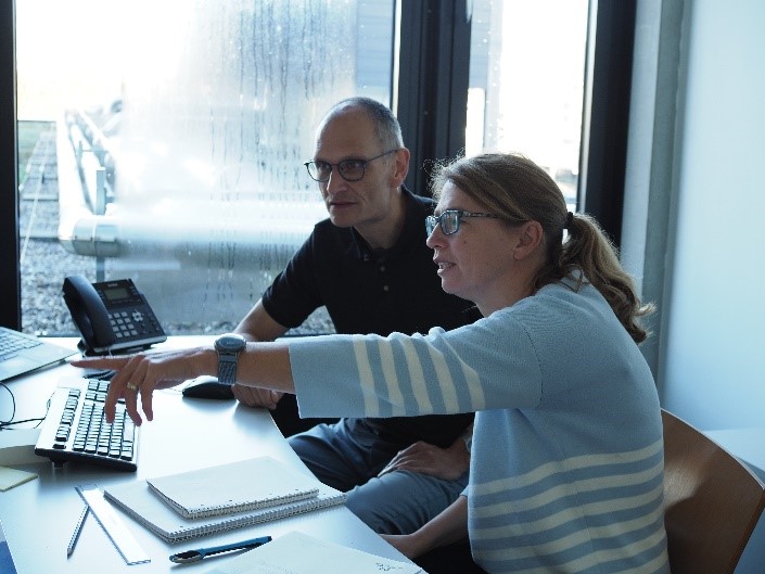 Marion Walker at her desk with a colleague.
